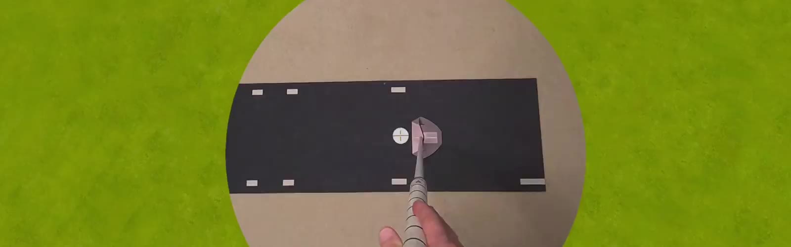First-person view from the headset: a real putter and ball on the dark mat, then the virtual ball rolling away across the green with its path drawn behind it.