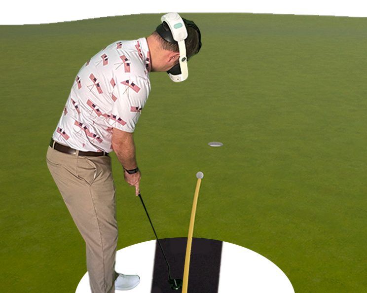 A golfer in a Meta Quest headset standing over the ball on the mat, the virtual green stretching out ahead of him with the ball on its way to the hole.