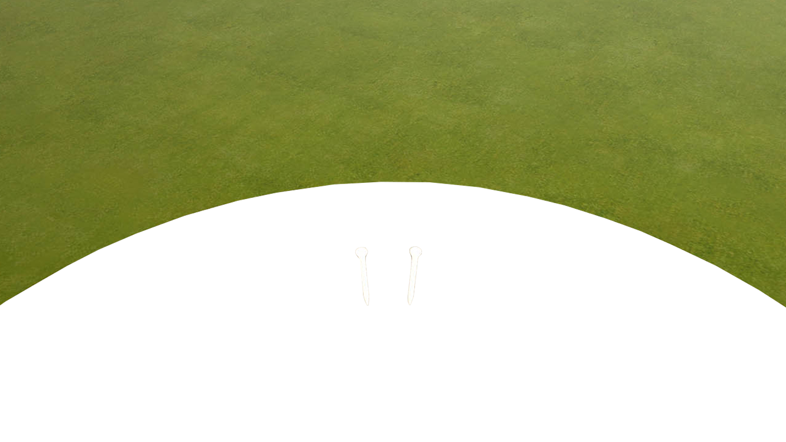 Two virtual tees standing a ball's width apart on the passthrough mat, the green rising beyond them.